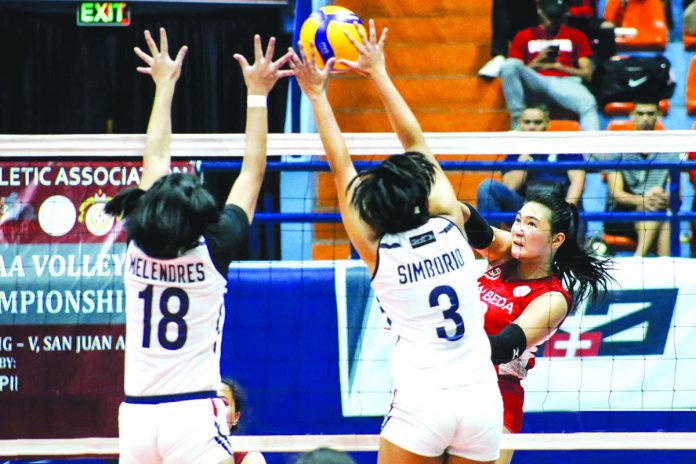 sports-volleyball San Beda University Lady Red Spikers’ Franchesca Racracquin with a score against the Letran Lady Knights’ defense. TIEBREAKER TIMES PHOTO