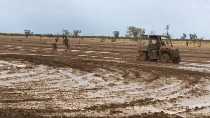 A buggy pulls people, sliding around in the mud, as they celebrate the rainfall in Winton, Queensland, Australia on Jan. 15 in this still image taken from social media video. TEONIE DWYER VIA REUTERS