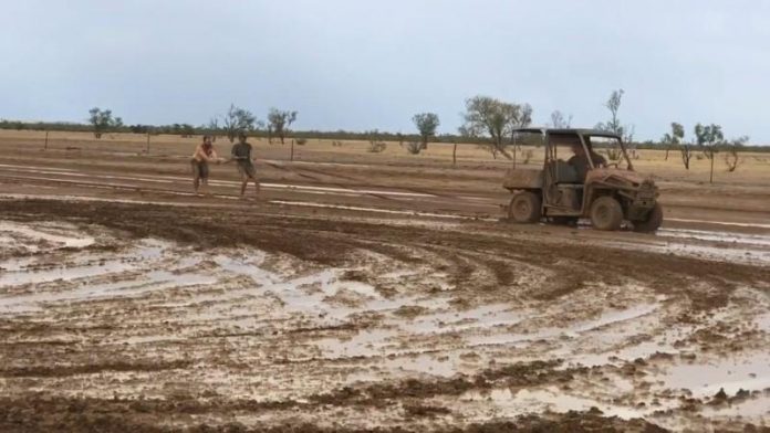 world Australia A buggy pulls people, sliding around in the mud, as they celebrate the rainfall in Winton, Queensland, Australia on Jan. 15 in this still image taken from social media video. TEONIE DWYER VIA REUTERS