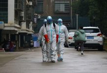 Wuhan to build 2 hospitals as virus death toll rises to 56 Workers from local disease control and prevention department in protective suits disinfect a residential area following the outbreak of a new coronavirus, in Ruichang, Jiangxi province, China on Jan. 25. CNSPHOTO VIA REUTERS