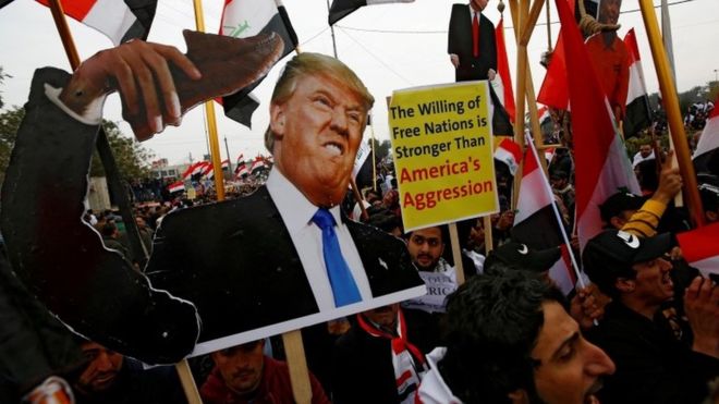 Demonstrators are seen carrying an image of United States (US) President Donald Trump during a protest aimed at pressuring US troops to leave Iraq. REUTERS