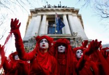 “Red Brigade” activists gesture as they participate in a demonstration against the Australian government’s alleged inaction over climate change despite the bushfires crisis, outside the Australian Embassy in London, Britain on Jan. 10. REUTERS/HENRY NICHOLLS