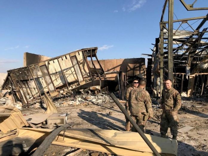United States soldiers are seen at the site where an Iranian missile hit at Ain al-Asad air base in Anbar province, Iraq. REUTERS/JOHN DAVISON