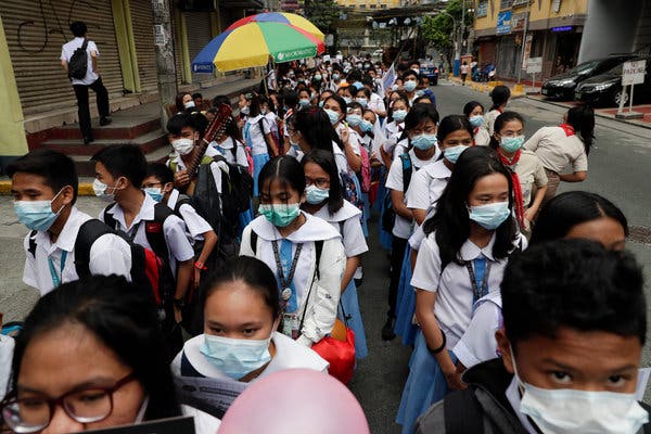 Students wearing protective masks during a school activity in Manila. AP