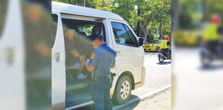 Personnel of the Malay municipal police station flag down this vehicle at a border control checkpoint here. The local government unit put up checkpoints in the boundaries of the town to lessen the risk of spreading the corona virus disease 2019 (COVID-19). MALAY AKLAN PNP