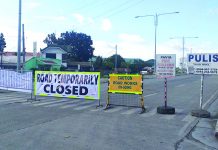 The Department of Public Works and Highways installed this road closure signs leading to the Aganan Bridge in Barangay Aganan, Pavia, Iloilo on Saturday. The decade-old bridge rendered impassable as workers started repairing its damaged portion. IME SORNITO/PN