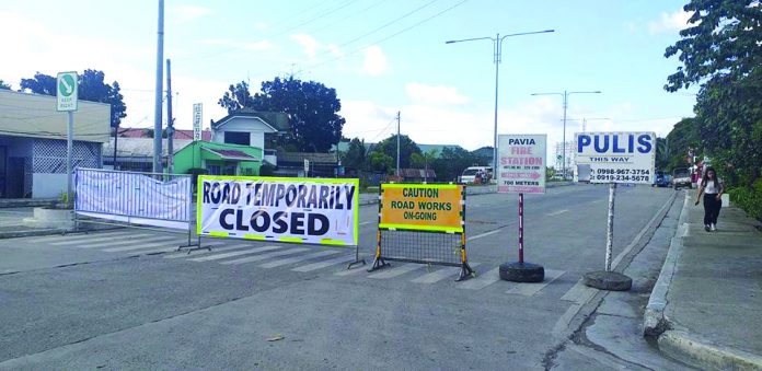 The Department of Public Works and Highways installed this road closure signs leading to the Aganan Bridge in Barangay Aganan, Pavia, Iloilo on Saturday. The decade-old bridge rendered impassable as workers started repairing its damaged portion. IME SORNITO/PN
