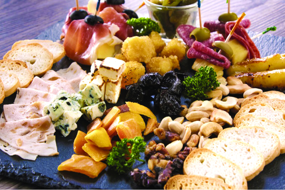 Assorted charcuterie at the appetizer station pairs perfectly with the free glass of wine.