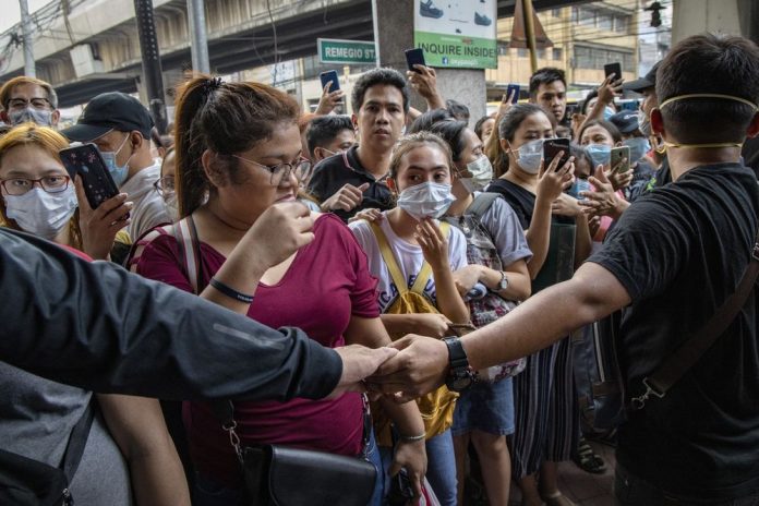 Corona Virus Philippines People wait outside a store to purchase protective masks in Manila on Jan. 31. Getty Images