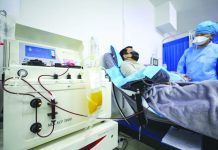 Dr. Kong Yuefeng, a recovered COVID-19 patient who has passed his 14-day quarantine, donates plasma in the city's blood center in Wuhan in central China's Hubei province on Feb. 18, 2020. CHINATOPIX/AP