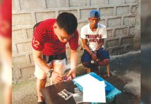 ‘Shabu pedder’ falls in buy-bust An antidrug officer inspects items seized from drug suspect Edmar Malunes. He was nabbed in an entrapment operation in his residence in Barangay 8, Bacolod City on Feb. 17. POLICE STATION 2/BCPO