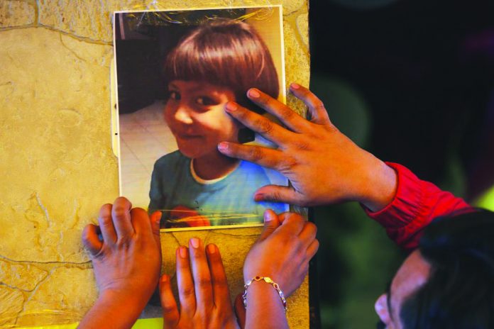 Relatives post a photo of Fatima, a 7-year-old girl who was abducted from the entrance of the Enrique C. Rebsamen primary school and later murdered, at her home in Mexico City, Monday, Feb. 17, 2020. AP