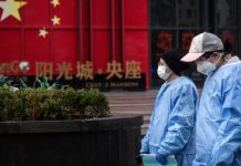 First COVID-19 death confirmed in Europe Two women wear protective masks and gowns as they walk in the streets of Wuhan, China, on Feb. 10, 2020. Getty Images