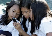 DEPED-6 CLARIFIES: Cellphones barred during class hours only, total ban needs stakeholder approval Students using a cell phone for text messaging, Quezon City, Philippines. Bullit Marquez/AP