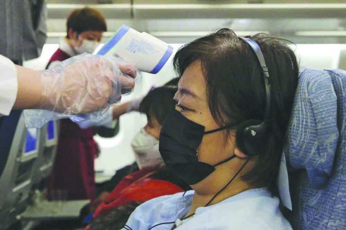 Hong Kong reports virus death Stewardesses take temperatures of passengers as a preventive measure for the coronavirus on an Air China flight from Melbourne to Beijing before it land at Beijing Capital International Airport in China, Tuesday, Feb. 4, 2020. CHINATOPIX VIA AP