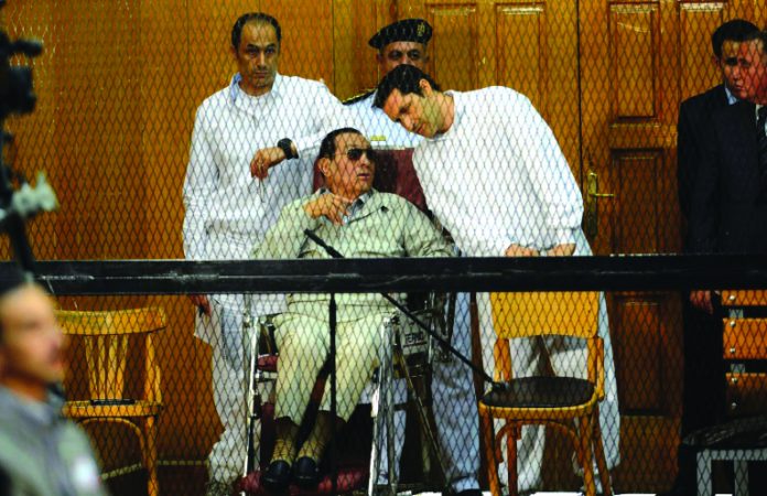 Hosni Mubarak Former Egyptian president Hosni Mubarak, who faced multiple charges after his overthrow, including over the deaths of protesters in 2011 and for corruption, appeared with his two sons Alaa (R) and Gamal at their trial in Cairo in September 2013. AFP