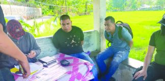 Antidrug officers inspect items seized from Junny Cris Delonguines and Lord Rubias. They were caught in an entrapment operation outside the Aklan Rehabilitation Center in Barangay Nalook on Feb. 8. RODNEL AGUIRRE