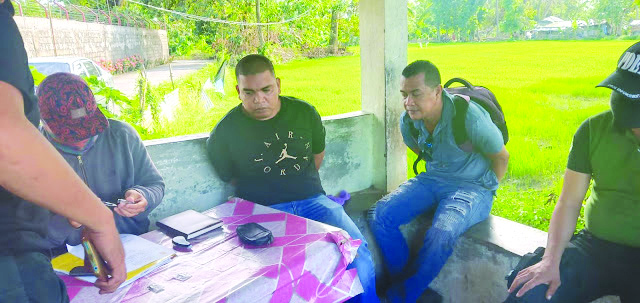 Junny Cris Delonguines and Lord Rubias Antidrug officers inspect items seized from Junny Cris Delonguines and Lord Rubias. They were caught in an entrapment operation outside the Aklan Rehabilitation Center in Barangay Nalook on Feb. 8. RODNEL AGUIRRE