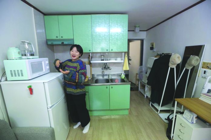 Kim Da-hye, a 29-year-old South Korean, talks about her semi-basement apartment in Seoul, South Korea, Saturday, Feb. 15, 2020. For many South Koreans, the image of a cramped basement apartment portrayed in the Oscar-winning film “Parasite” rings true, bringing differences in their social status to worldwide attention. AP