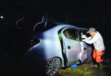 A rescuer tries to assist the victims of the road accident in Barangay Tortosa, Manapla, Negros Occidental on Feb. 21. MANAPLA MUNICIPAL POLICE STATION