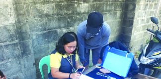 Antidrug officers inspect items seized from a 17-year-old minor. He was nabbed in an entrapment operation in Barangay 2 on Feb. 15. POLICE STATION 2/BCPO