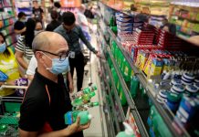 People hoard bottles of alcohol after the Philippine government confirmed the first case of the new coronavirus in the country, in Makati City. PBS