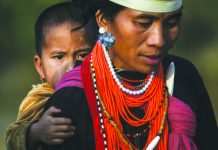 A Naga tribeswoman carrying a child at the end of an overnight ceremony to bless the harvest in Satpalaw Shaung village in Myanmar's Sagaing region. AFP