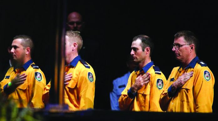 New South Wales Rural Fire Service personnel attend a state memorial honouring victims of the Australian bushfires at Qudos Bank Arena in Sydney, New South Wales, Australia, Feb. 23, 2020. REUTERS