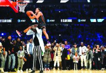 Orlando Magic's Aaron Gordon soars past seven-foot-five Boston Celtics center Tacko Fall for his final trick of the 2020 All-Star Slam Dunk competition in Chicago, USA on Feb. 15. YAHOO SPORTS