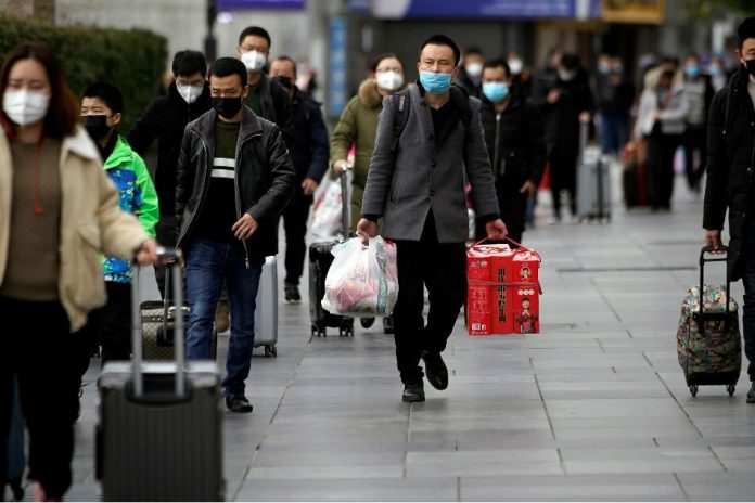 Passengers wearing masks walk outside the Shanghai railway station in Shanghai Passengers wearing masks walk outside the Shanghai railway station in Shanghai, China. REUTERS
