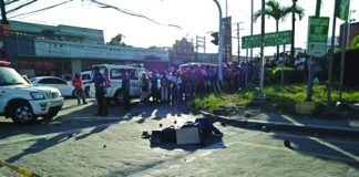 Police Patrolman Eric Alcosaba lies dead on the road after four unidentified gunmen shot him multiple times along Circumferential Road in Barangay Villamonte, Bacolod City around 3:50 p.m. on Saturday. ARCHIE ALIPALO/PN