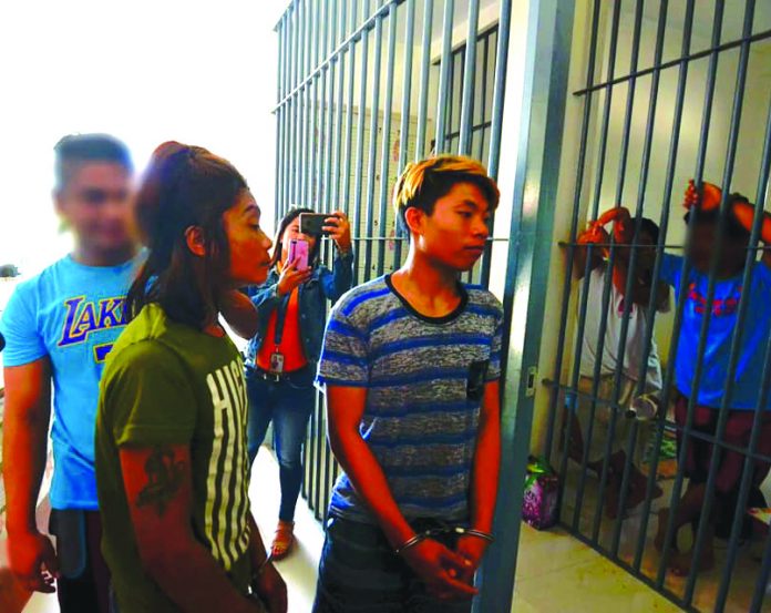 Renesto and Rene Boy Suspeno Murder suspects (from right) Renesto and Rene Boy Suspeno and a 16-year-old minor are being escorted to the lockup facility of municipal police station of Miag-ao, Iloilo on Feb. 25. IAN PAUL CORDERO