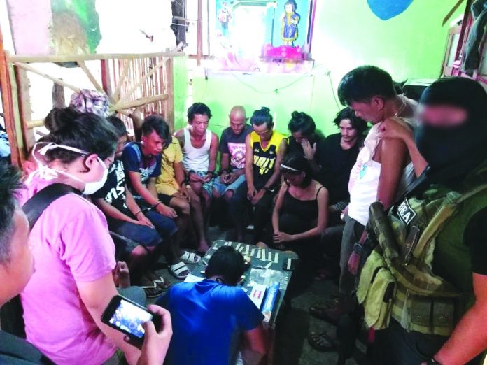 Antidrug officers inspect items seized from 16 drug suspects in Barangay 6, San Carlos City, Negros Occidental on Feb. 25. PDEA REGION VI