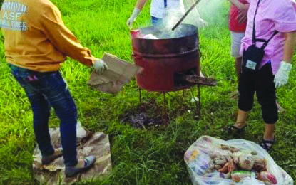 Sanitary inspectors of the Provincial Task Force on African swine fever (ASF) destroy pork-based products seized in Bacolod-Silay Airport. The action is part of the provincial government’s plan to deny the entry of ASF in this province. PNA