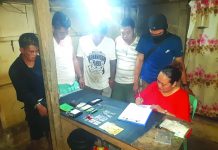 An antidrug officer inspects items seized from John Rey Tayucon, Dexter Dagatan, Elesaldie Cadalman and Mark Bille. The suspects were arrested in an entrapment operation in Barangay Villamonte, Bacolod City on Feb. 7. POLICE STATION 2/ BCPO