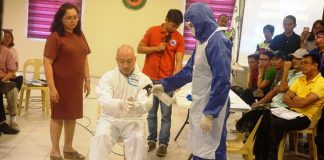 Personnel of the Bacolod City Disaster Risk Reduction and Management Office demonstrate how to put on personal protective equipment in case they are called to respond to confirmed coronavirus disease cases. The city government recently purchased at least 1,000 sets of personal protective equipment that P3,750 each. BACOLOD CITY PIO