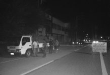 Police officers inspect the transport truck of Edwin Gerona, Jake Gerona and Nolasco Cahilig Jr containing 3,100 liters of gasoline in 155 drums. STEPHEN LOUIE CHECA/PN