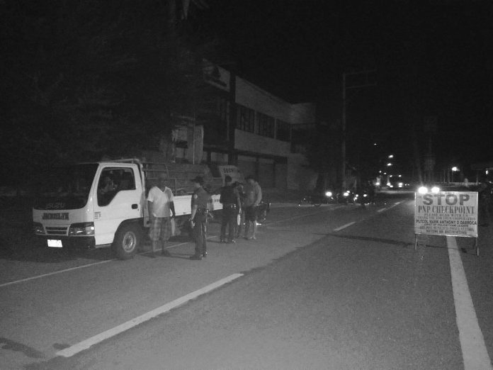 region-antique Police officers inspect the transport truck of Edwin Gerona, Jake Gerona and Nolasco Cahilig Jr containing 3,100 liters of gasoline in 155 drums. STEPHEN LOUIE CHECA/PN