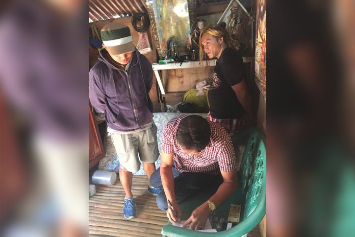 shabu Antidrug officers inspect items seized from Rogelio Panonce Jr. He was nabbed in an entrapment operation in Barangay Banago, Bacolod City on Feb. 14. CDEU/BCPO