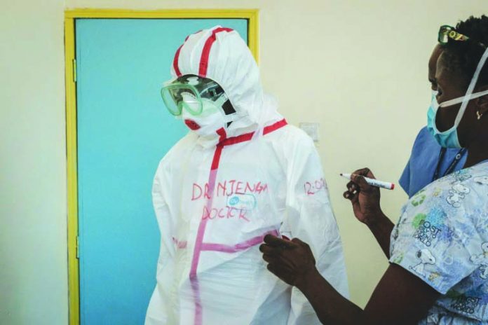 Africa Doctor A doctor gets suited up for visiting a quarantine ward at Kenyatta National Hospital in Nairobi. AFP