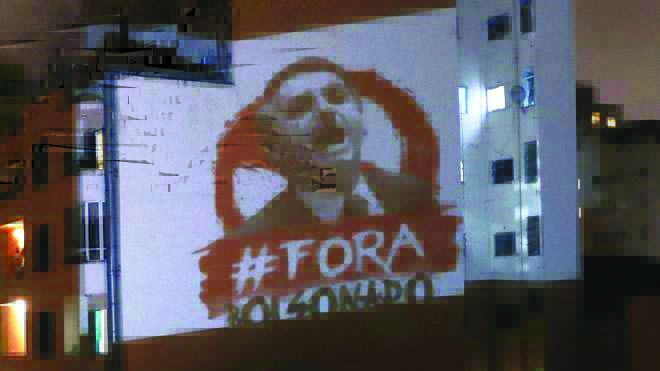 An image saying “Out Bolsonaro” is projected onto a building in Sao Paulo, Brazil An image saying “Out Bolsonaro” is projected onto a building in Sao Paulo, Brazil. REUTERS
