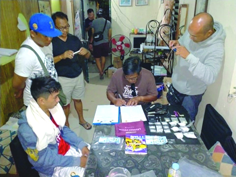 Antidrug officers inspect items seized from Mark Sy Antidrug officers inspect items seized from Mark Sy, who was nabbed in an entrapment operation in Barangay Estefania, Bacolod City on March 15. POLICE STATION 2/BCPO