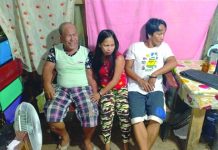Drug suspects Armando Galgarin, Raquel Galgarin and Arlie Galgarin sit down while antidrug personnel inspect items seized from them during an entrapment operation in Barangay Banago, Bacolod City on March 12. POLICE STATION 2