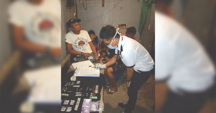 Bobby Palomo; Erikson Cordova, John Paul Guzon; Kube Salaza; and Jonathan Salcedo An antidrug officer inspect items seized from Bobby Palomo; Erikson Cordova, John Paul Guzon; Kube Salaza; and Jonathan Salcedo, who were nabbed in an entrapment operation in Barangay 8 Bacolod City on March 23. POLICE STATION 2/BCPO