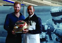 Britain's Prince Harry and Formula One World Champion Lewis Hamilton pose with one of Hamilton's helmet as they visit the Silverstone Experience at Silverstone circuit, in Towcester, Britain on March 6. REUTERS/PETER NICHOLLS/POOL