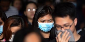 Commuters mostly wearing face masks cross at a busy street in Mandaluyong on February 5, 2020. ABS-CBN News