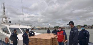 Philippine Coast Guard personnel get ready to transport these boxes of family food packs from the Department of Social Welfare and Development to Negros Occidental from the seaport of Iloilo City via a ship of the Bureau of Fisheries and Aquatic Resources. DSWD Region 6 has prepositioned 24,200 family food packs should local government units need more for their constituents adversely affected by the ongoing enhanced community quarantine aimed at containing the spread of the coronavirus disease 2019. IAN PAUL CORDERO/PN