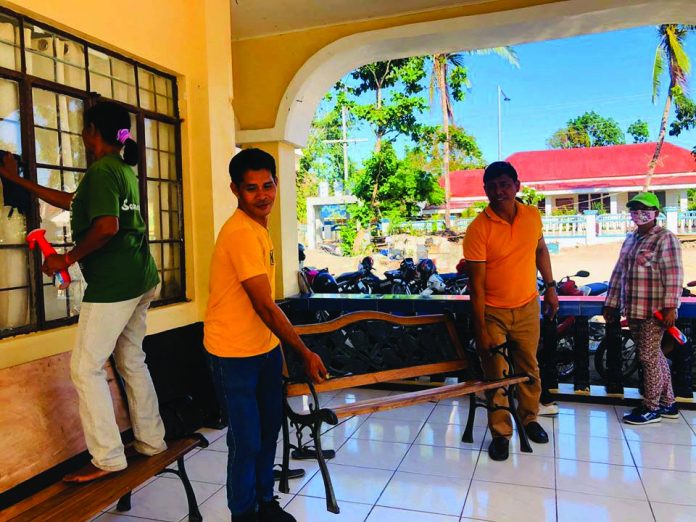 Employees of the local government unit of Caluya, Antique disinfect their municipal hall as one of the preventive measures against the coronavirus disease 2019. MUNICIPALITY OF CALUYA