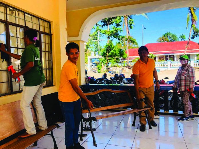 Employees of the local government unit of Caluya, Antique disinfect their municipal hall as one of the preventive measures against the coronavirus disease 2019. MUNICIPALITY OF CALUYA