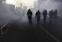 Iran says worsening outbreak could strain health facilities Firefighters disinfect a street against the new coronavirus, in western Tehran, Iran, Friday, March 13, 2020. AP
